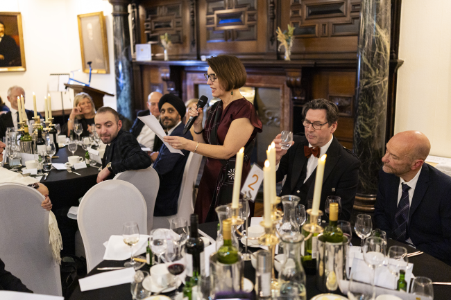 A woman addressing a room